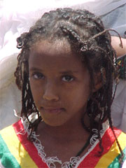 Ethiopian girl with parted eyebrow and full rounded forehead.